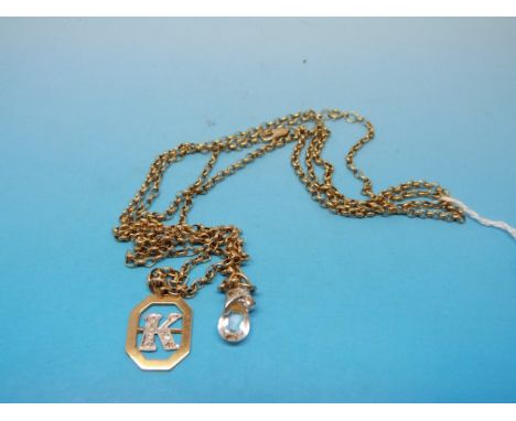 Two 9ct gold necklaces one with a 9ct gold pendant set with diamonds in the shape of a 'K' (15g)