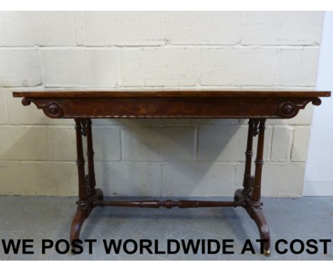 A Victorian mahogany and satinwood sofa table raised on four turned columns united by a turned and tapered stretcher (length 