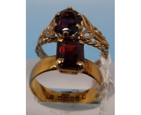 A 22ct gold ring set with a garnet (size K, 4g) together with a 9ct gold ring set with a garnet (size N, 2g)