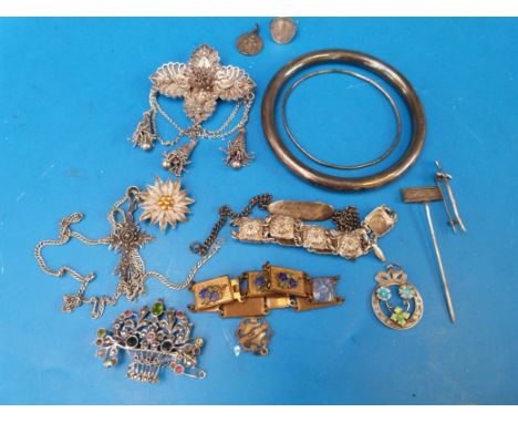 A hallmarked silver bangle, a silver brooch set with peridot, sapphires and rubies, a hallmarked silver and enamel pendant, a
