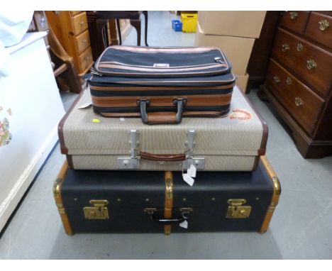 A vintage steamer trunk and two other items of luggage