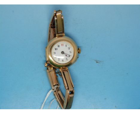 A 15ct gold watch with an enamel face on a 15ct gold expanding bracelet 