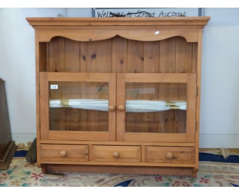 A hanging pine glazed cupboard with three drawers and shelf (W94cm x D21cm x H87cm)