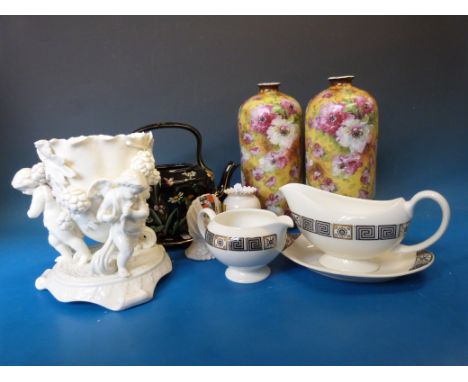 An enamelled Victorian ceramic teapot, a centrepiece supported by three putti, Goss, Carltonware, a pair of decorative vases 