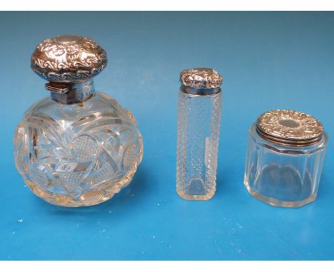 Three various hallmarked silver-mounted dressing table bottles, including a globe shaped example