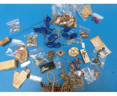 A collection of jewellery to include beads, cufflinks, brooches, necklaces, porcelain brooch, mother of pearl counters, agate
