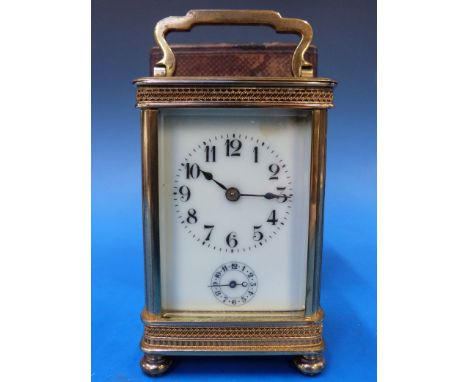 A French carriage clock with ivory coloured enamel dial, Arabic numerals and secondary dial for alarm facility, the case with