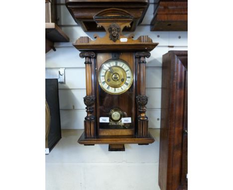 A German wall clock with two-train movement in regulator style, with gilt decoration to the dial, ivory coloured chapter ring