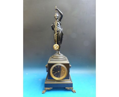 A figural mystery clock in slate on ebonized bracket with relief decoration and two train movement, case on lion paw feet and