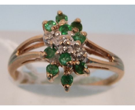 A 9ct gold ring set with diamonds and emeralds in a cluster (size K)