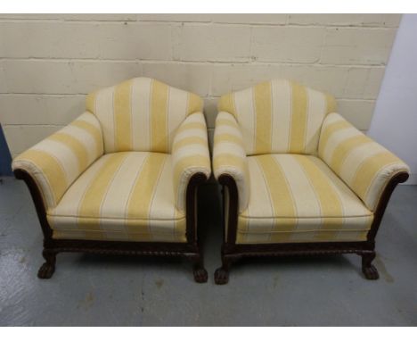 A carved walnut three piece suite raised on ball and claw feet and comprising three seater sofa and two armchairs all upholst
