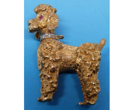 An 18ct gold brooch in the form of a poodle with a textured finish, diamond collar and ruby eyes.  