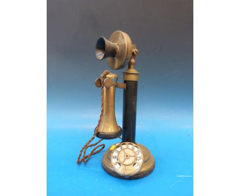 A brass candlestick telephone