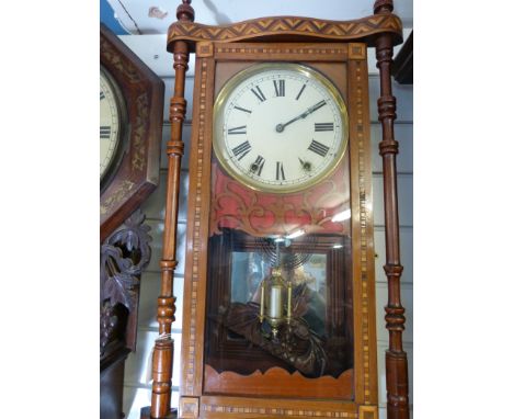 An American wall clock with ornate marquetry inlaid case, and turned decoration, mirror backed