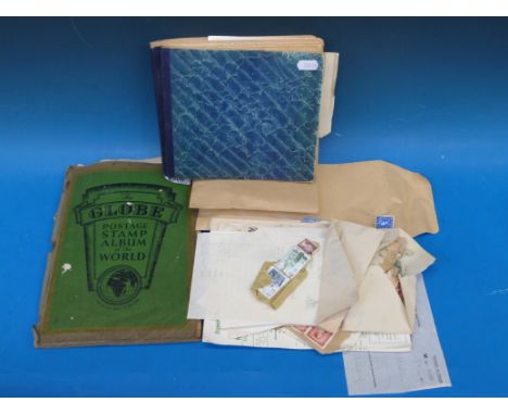 A stamp collection including The Globe stamp album and one other album of colonial stamps, and sundry loose stamps (all reign