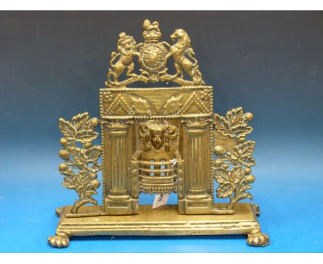 A 19thC brass mantelpiece model of an open fire with pre-Victorian royal crest, raised on lion paw feet, possibly a spill hol