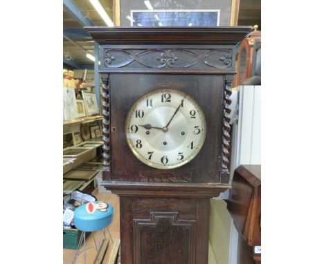 An oak-cased grandmother long cased clock c1920 with quarterly chime mechanism, Arabic numerals on silvered dial and barley t