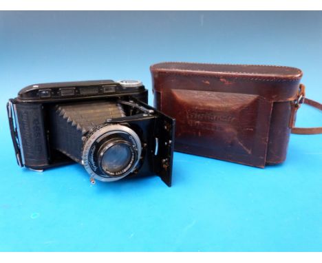A Voigtlander RF folding camera in leather case