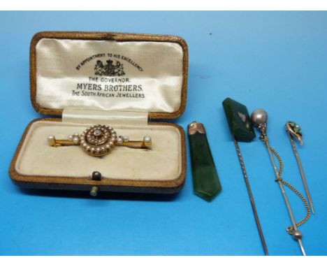 A yellow metal brooch marked 15ct set with a central diamond surrounded by circles of seed pearls, a stick pin with a miniatu