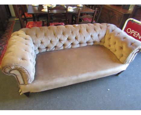 A button back Chesterfield sofa, tapering front legs on castors 