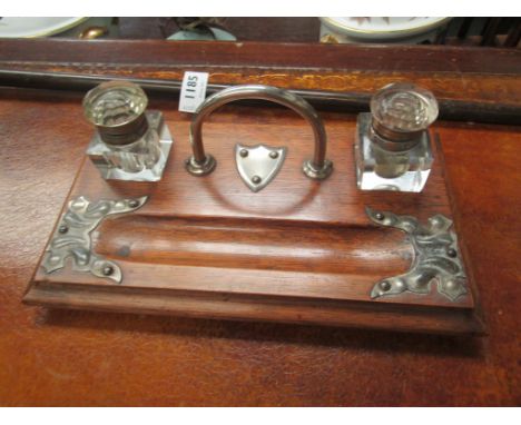 An early 20th Century oak desk stand with twin inkwell compartment  