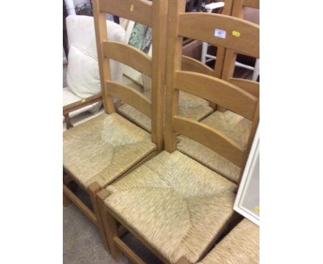 A set of six beech ladder back and rush seated dining chairs 