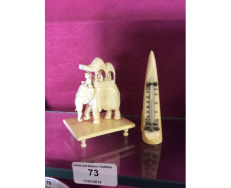 An ivory thermometer and an Indian carved ivory elephant