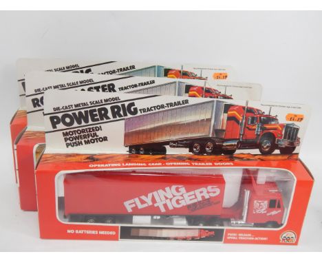A Road Master die cast metal tractor and trailer Pennzoil, another similar and a Flying Tigers tractor trailer, boxed (3).