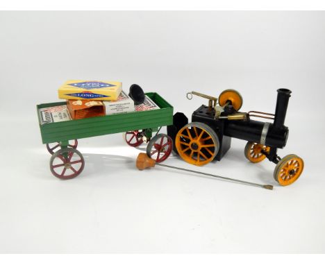 A Mamod live steam traction engine and trailer.