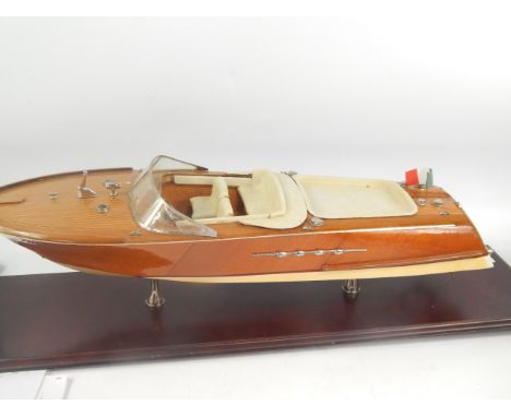 A scale model of an Italian Riva motor boat, with wooden hull, leather interior, on stand, 69cm long.