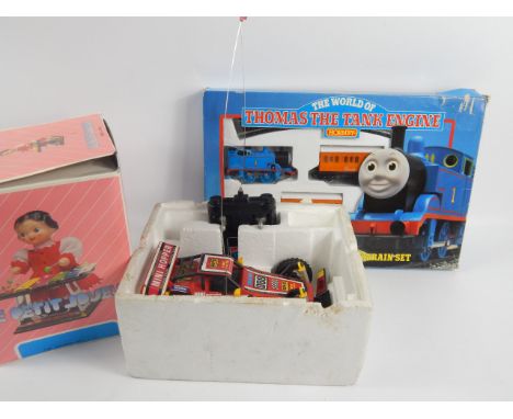 Various toys, including a Hornby Thomas Tank Engine small train set, a Taiyo remote control car, a circus performer, clockwor