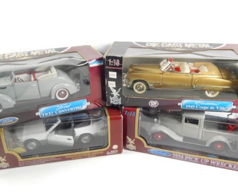 Four 1:18 scale die cast model vehicles, with original boxes.