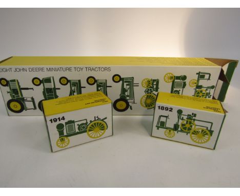 A John Deere miniature toy tractor die cast set, to include 1892 Froelich tractor etc, boxed (8).