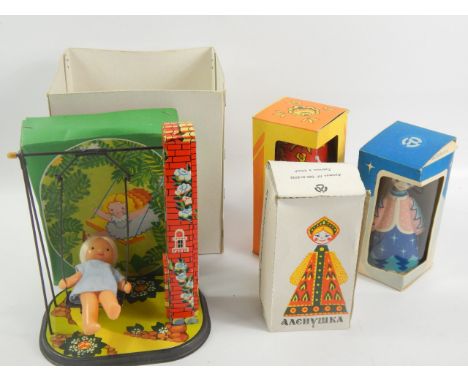 Various Russian tin plate toys etc., to include a girl on a swing, doll, two figures (4)