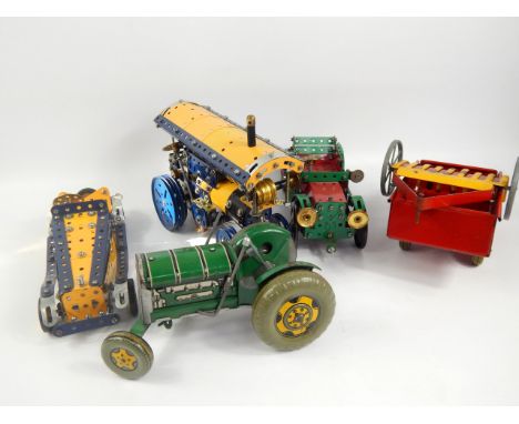 Four Meccano vehicles, comprising a traction engine, two cars and tractor with trailer.