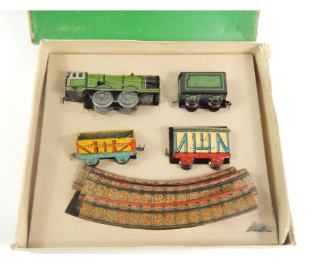 A Triang Minic die-cast model clockwork train set, with green engine tender, two goods wagons and track, associated box
