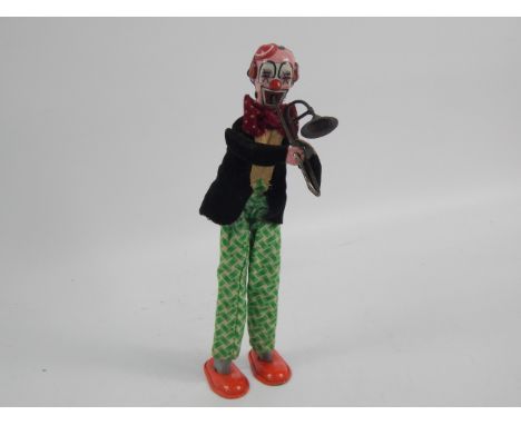 A tin plate model of a trombone playing clown, 23cm high