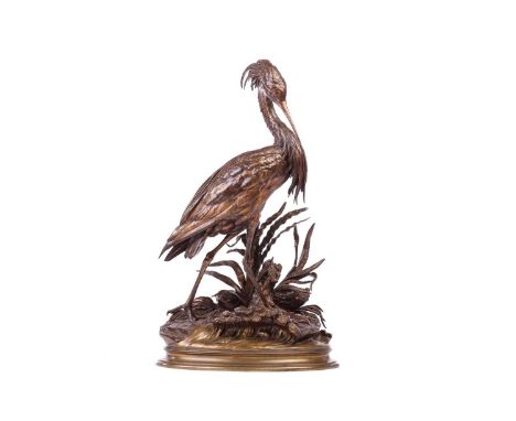 Jules Moigniez (French 1835-1894), a patinated bronze model of a heron standing on a naturalistic base of reeds and rocks, si