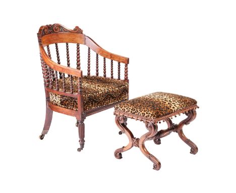 A late regency, possibly colonial Indian rosewood hoop-backed armchair and "X" framed Indian rosewood footstool, the chair wi
