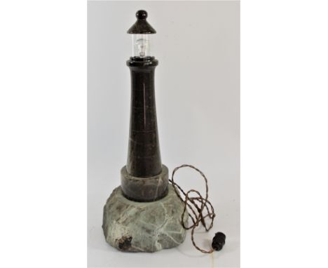 Of Cornish Interest - a serpentine marble table lamp model of a lighthouse, the tapering column mounted on a granite base, 43