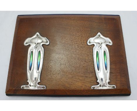 An Art Nouveau Silver and enamel mounted oak desk jotter by Charles S Green & Co Ltd, hallmarked Birmingham 1904, opening to 