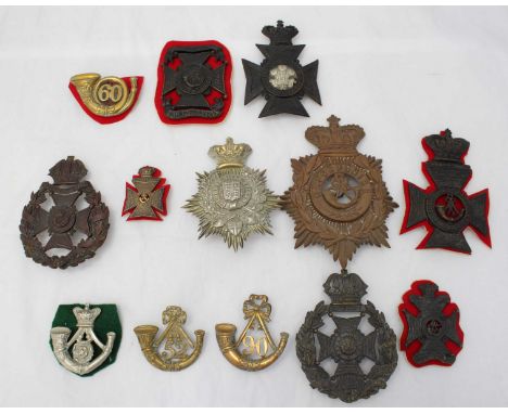 A collection of thirteen various Rifle Brigade and Light Infantry helmet plates and cap badges including Oxfordshire, London 