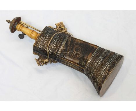 A late 19th / early 20th century Persian metal-mounted cow horn powder flask, with carved geometric decoration and alternatin