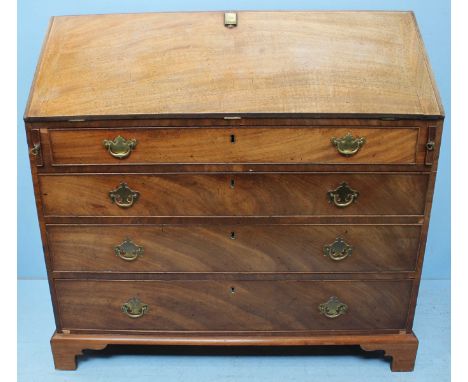 A George III mahogany bureau, the fall front opening to reveal a fitted interior with small, central cupboard door, flanked b