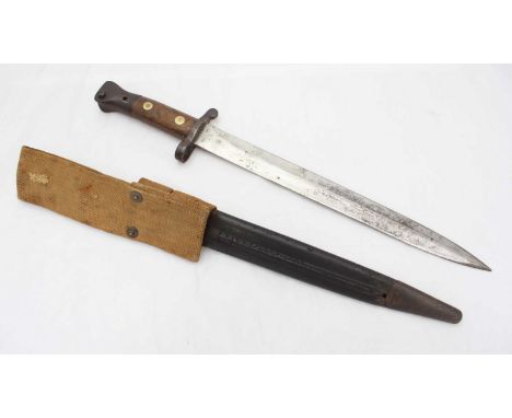 A Victorian Enfield bayonet, with wooden grip, in canvas and leather scabbard.