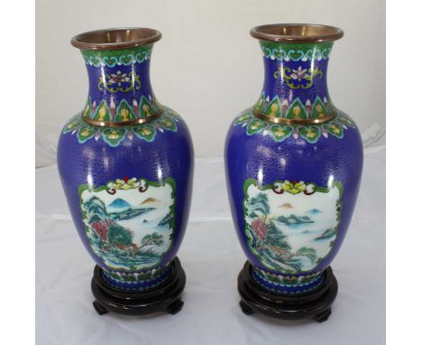 A pair of 20th century oriental cloisonné enamel vases decorated with blue and gilt floral designs throughout, with separate 