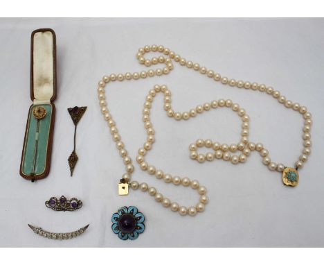 A Silver filigree and enamel brooch set with a cabochon amethyst to the middle, together with a 9ct gold brooch set with blue