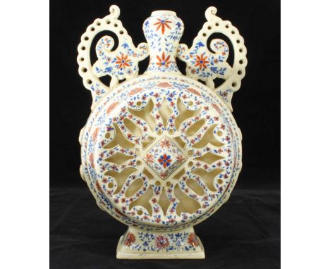 A late 19th century Fischer reticulated pottery twin handled moon flask, highly decorated with blue and red floral design on 