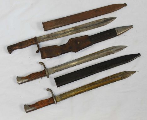 A German M1898 pattern knife-bayonet with serrated back, 14.5-inch fullered blade, wooden handle, leather scabbard and belt f