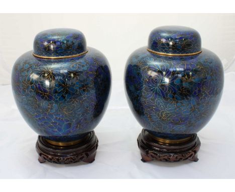 A pair of 20th century oriental cloisonné enamel lidded ginger jars with dark blue and gilt floral decoration, with separate 